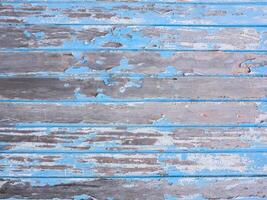 background of old wooden blue planks whose paint is faded and peeling photo