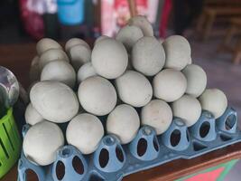 Salted boiled duck eggs are displayed and sold photo