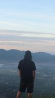 A Man Enjoying the Morning Atmosphere on Arang Hill, Gorontalo photo