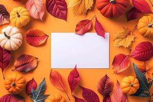 Autumn orange background with white sheet of paper for copy space in the middle with falling autumn yellow, red leaves, colored ripe pumpkins. Template for Thanksgiving, Halloween, October holidays photo