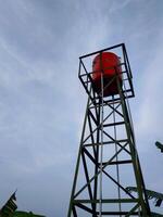 water tower, water tank concrete tower with the sky on background. photo
