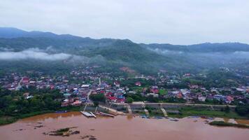Aerial view of the mighty Mekong River winding from Chiang Khong, showing the vastness and beauty of the muddy waterway contrasting with the surrounding lush mountains and Laos villages. video