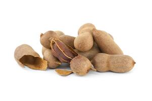 Tamarind whole and cracked open on white background photo