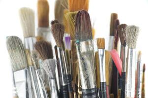 Assortment of various types and sizes of paintbrushes photo