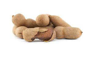 Tamarind whole and cracked open on white background photo