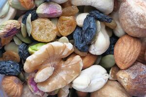 Photograph of a highresolution macro of an assorted mix of nuts and dried fruits photo