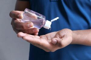 hands using wash hand sanitizer, close up photo