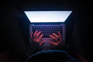 Close up of hacker hand stealing data photo