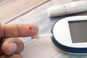 Flesh blood from diabetes patient finger to test glucose level blood . photo