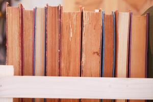A lot of books are on the shelf in a public library or bookstore photo