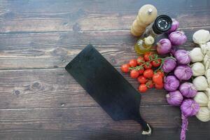 Healthy food selection with fresh vegetables and a chopping board on table photo