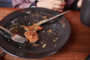An empty dirty plate with a fork. photo