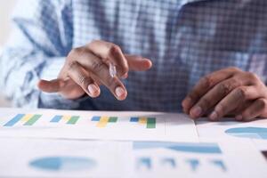 businessman analyzing financial chart on paper photo
