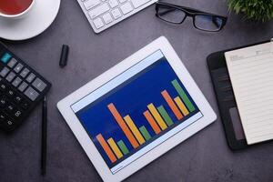 high angle view of bar chart on digital tablet on table photo