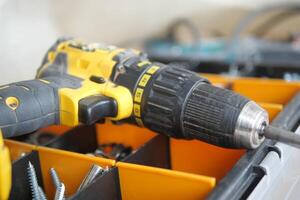 An electric screwdriver is on the floor, photo