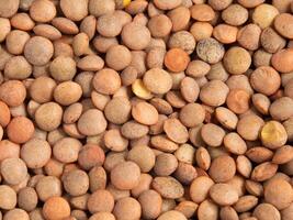closeup of raw organic lentil grains texture background photo