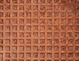 old rusty metal surface with square pattern, grunge abstract background photo