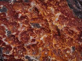 macro rough texture of stone surface in red color, natural abstract background photo
