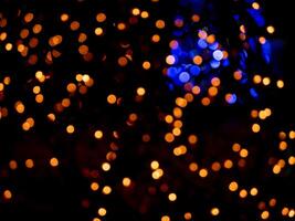 abstract blurred bokeh background, bright lights on a black background photo