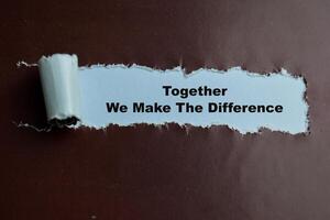 Concept of Together We Make The Difference Text written in torn paper. photo