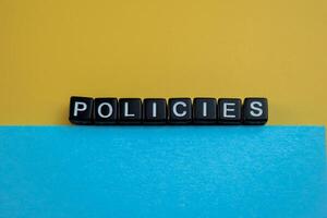 Concept of The wooden Cubes with the word Policies on wooden background. photo