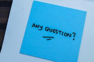 Concept of Any Question write on sticky notes isolated on Wooden Table. photo