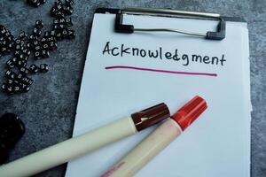 Concept of Acknowledgment write on paperwork isolated on wooden background. photo