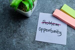 Concept of Problem Opportunity write on sticky notes isolated on Wooden Table. photo