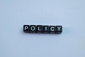 Concept of The wooden Cubes with the word Policy on wooden background. photo