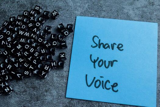 Concept of Share Your Voice write on sticky notes isolated on Wooden Table. photo