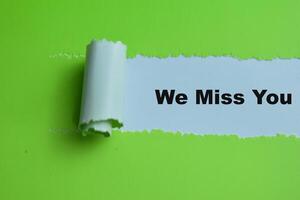 Concept of We Miss You Text written in torn paper. photo