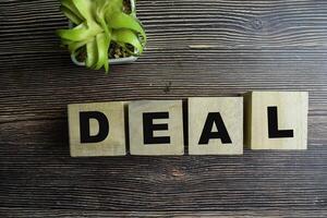 Concept of The wooden Cubes with the word Deal on wooden background. photo