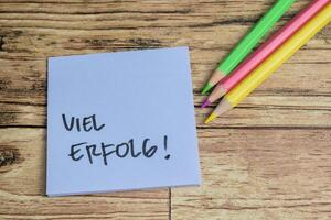Concept of Learning language - German. Viel Erfolg it means Good luck written on sticky notes. German language isolated on Wooden Table. photo