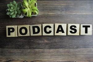 Concept of The wooden Cubes with the word Podcast on wooden background. photo