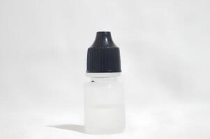 Small Bottle with Black Cap on White Background photo