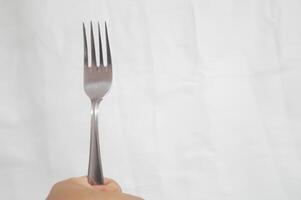 A fork is shown in a white background photo