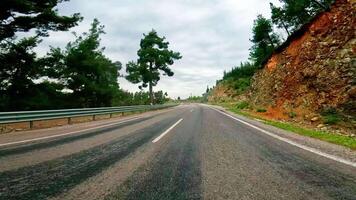 First-person footage of road trip along mountain pass. captures road trip on narrow mountain road. Scenic road trip journey through mountainous terrain. video