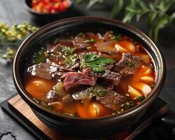 A bowl of wholesome broth, enriched with succulent steak pieces and nourishing wheat, offers a symphony of flavors photo