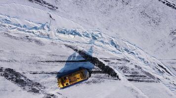 During winter, an aerial view shows a snowplow clearing snow from a road in cold conditions video