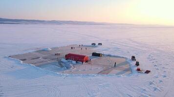 Ice rink on lake slice of winter paradise Ice rink on lake blend of fun and frosty landscape. Ice rink on lake captivating skaters amidst snowy tranquility Surrounded by cold haven for winter sports. video