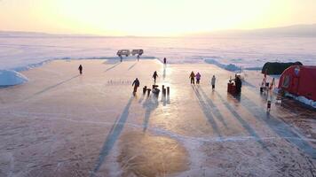 Ice rink on lake slice of winter paradise Ice rink on lake blend of fun and frosty landscape. Ice rink on lake captivating skaters amidst snowy tranquility Surrounded by cold haven for winter sports. video
