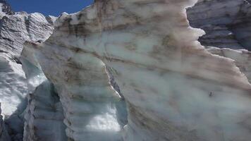 Aerial view of a glacier with ice formations against a backdrop of snowy wilderness video