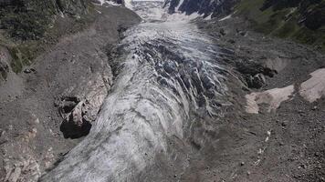 Experience the beauty of a glacier from above in a mountainous setting with a stunning aerial view video