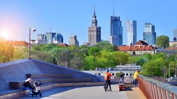 Warsaw, Poland. 11 April 2024. Bridge over the Vistula River intended only for pedestrians and cyclists. In the background, a panorama of the city with skyscrapers. photo
