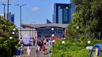 Warsaw, Poland. 8 June 2024. Crowd of people on Patelnia square in centrum city. The colloquial name. An important communication point on the city map with residents, tourists and buildings. photo