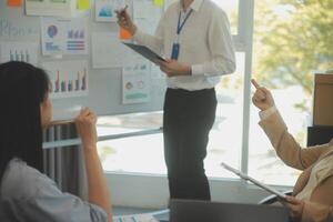 Business team collaboration discussing working analyzing with financial data and marketing growth report graph in team, presentation and brainstorming to strategy planning making profit of company. photo