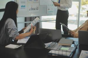 Business team collaboration discussing working analyzing with financial data and marketing growth report graph in team, presentation and brainstorming to strategy planning making profit of company. photo