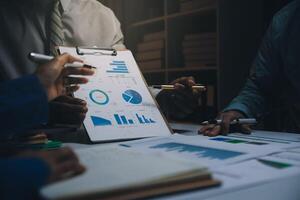 Business team meeting present, investor colleagues consultation and conference new strategy plan business and market growth on financial document graph report, Meeting and Talking. photo
