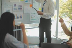 Business team collaboration discussing working analyzing with financial data and marketing growth report graph in team, presentation and brainstorming to strategy planning making profit of company. photo