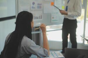 Business team collaboration discussing working analyzing with financial data and marketing growth report graph in team, presentation and brainstorming to strategy planning making profit of company. photo